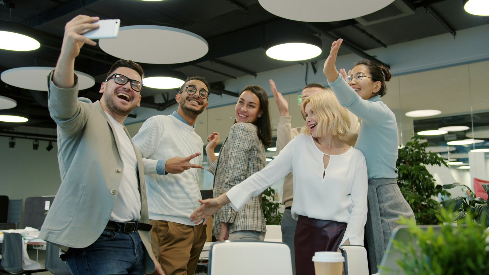 A team taking a selfie in a bright office